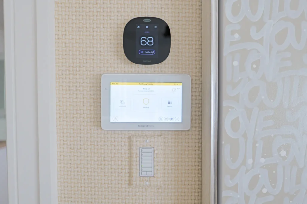 Premium home security system keypad custom wallpaper room with a lutron control, smart thermostat, and premium home security system keypad