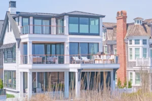 Custom Lutron privacy shades raised in an oceanfront Avalon, NJ home, preserving the ocean view while blocking sightlines from the beach. 