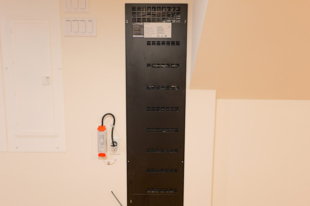 Lutron lighting control panel and power supply mounted in the utility area of a Stone Harbor, NJ home, installed by Cooltronics.