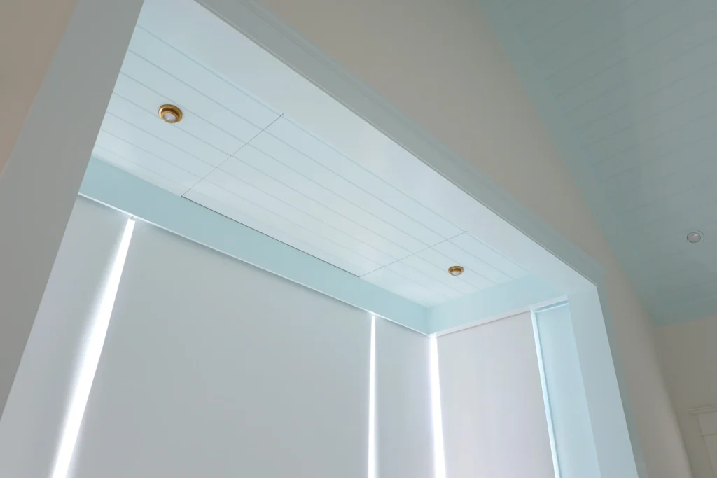 Detail of the custom ceiling-mounted drop-down TV stowed flush into the alcove ceiling of a Stone Harbor, NJ primary bedroom, installed by Cooltronics.