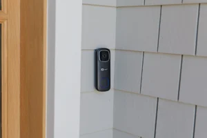 IC Realtime video doorbell mounted on the shingle exterior of a Stone Harbor, NJ home, installed by Cooltronics as part of the integrated surveillance system.