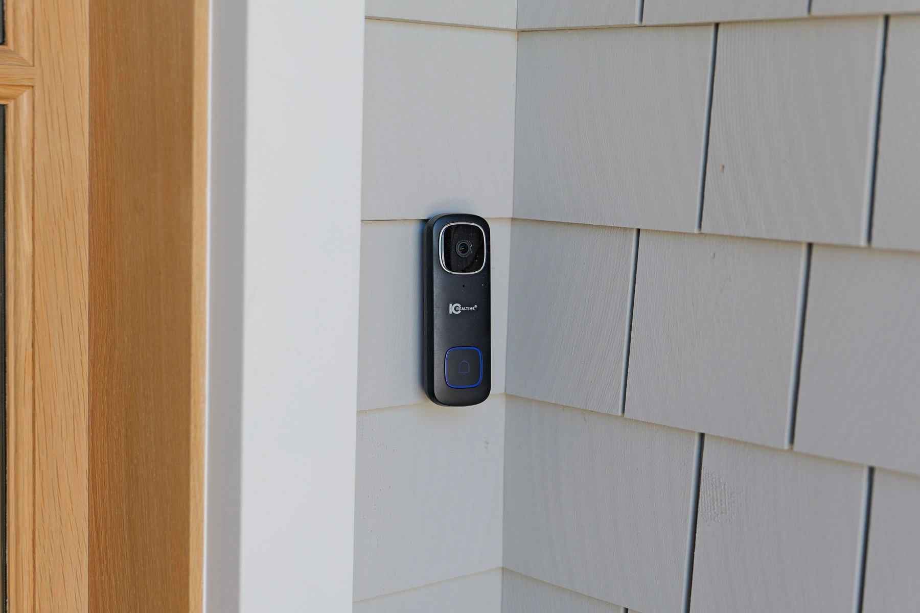 IC Realtime video doorbell mounted on the shingle exterior of a Stone Harbor, NJ home, installed by Cooltronics as part of the integrated surveillance system.
