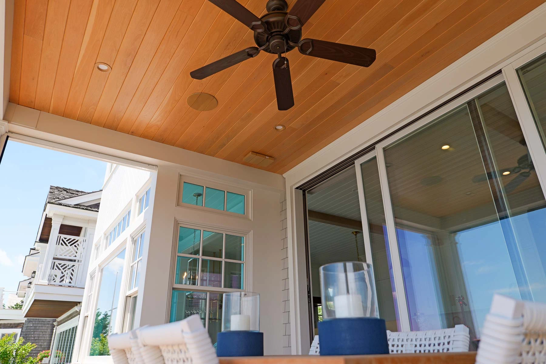 Custom-painted in-ceiling speaker flush-mounted into the wood ceiling of a covered outdoor porch at a Stone Harbor, NJ home, installed by Cooltronics.