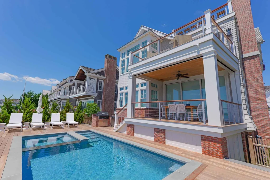 Pool deck and outdoor entertaining area at a Stone Harbor, NJ coastal home with Cooltronics smart home integration.