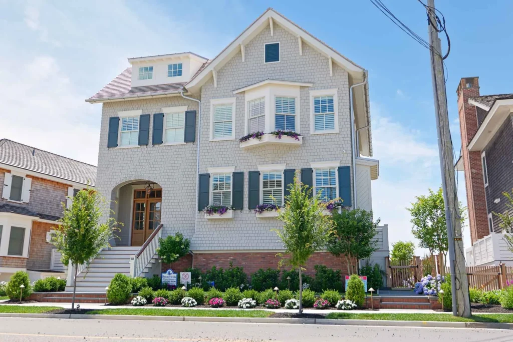 Front elevation of a three-story shingle-style coastal home in Stone Harbor, NJ, where Cooltronics completed a comprehensive smart home installation.